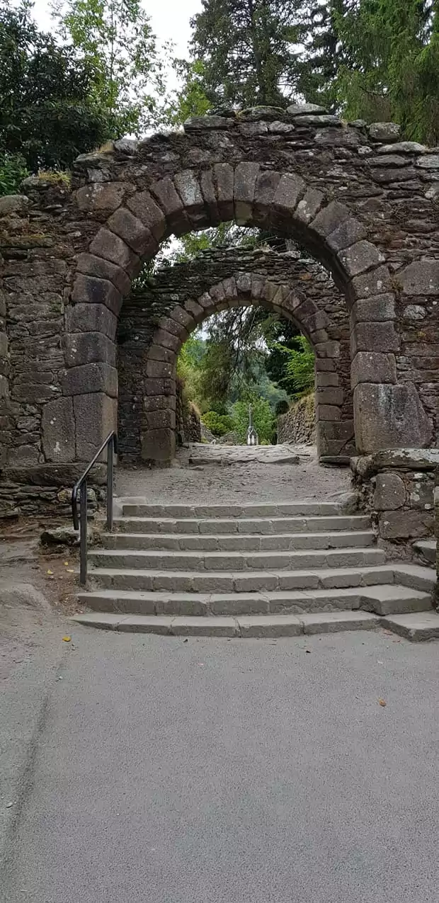 The entrance to the Glendalough monastery is decorated with a large cross carved into the side of the arch, bestowing a blessing on all travellers that pass through its gates.