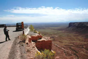 Edge of the viewpoint looking southwest, Monument Valley in the far distance. Photo by Drifter Don