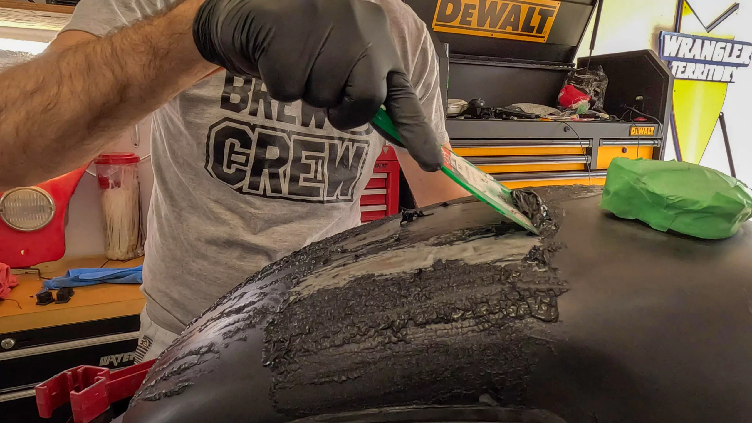 scraping paint off motorcycle gas tank to expose raw metal